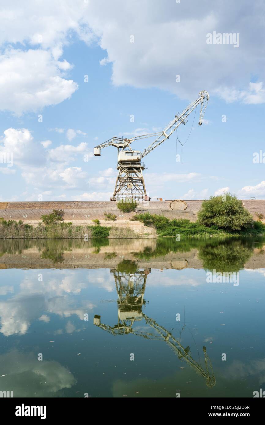 Heavy large industrial crane lifter at abounded port in sunny day Stock Photo