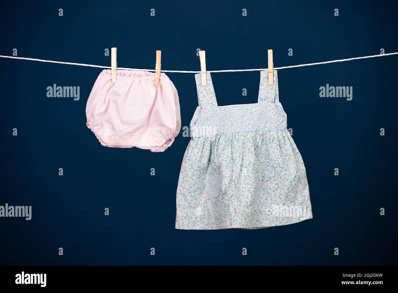 Baby clothes hanging on the clothesline Stock Photo - Alamy