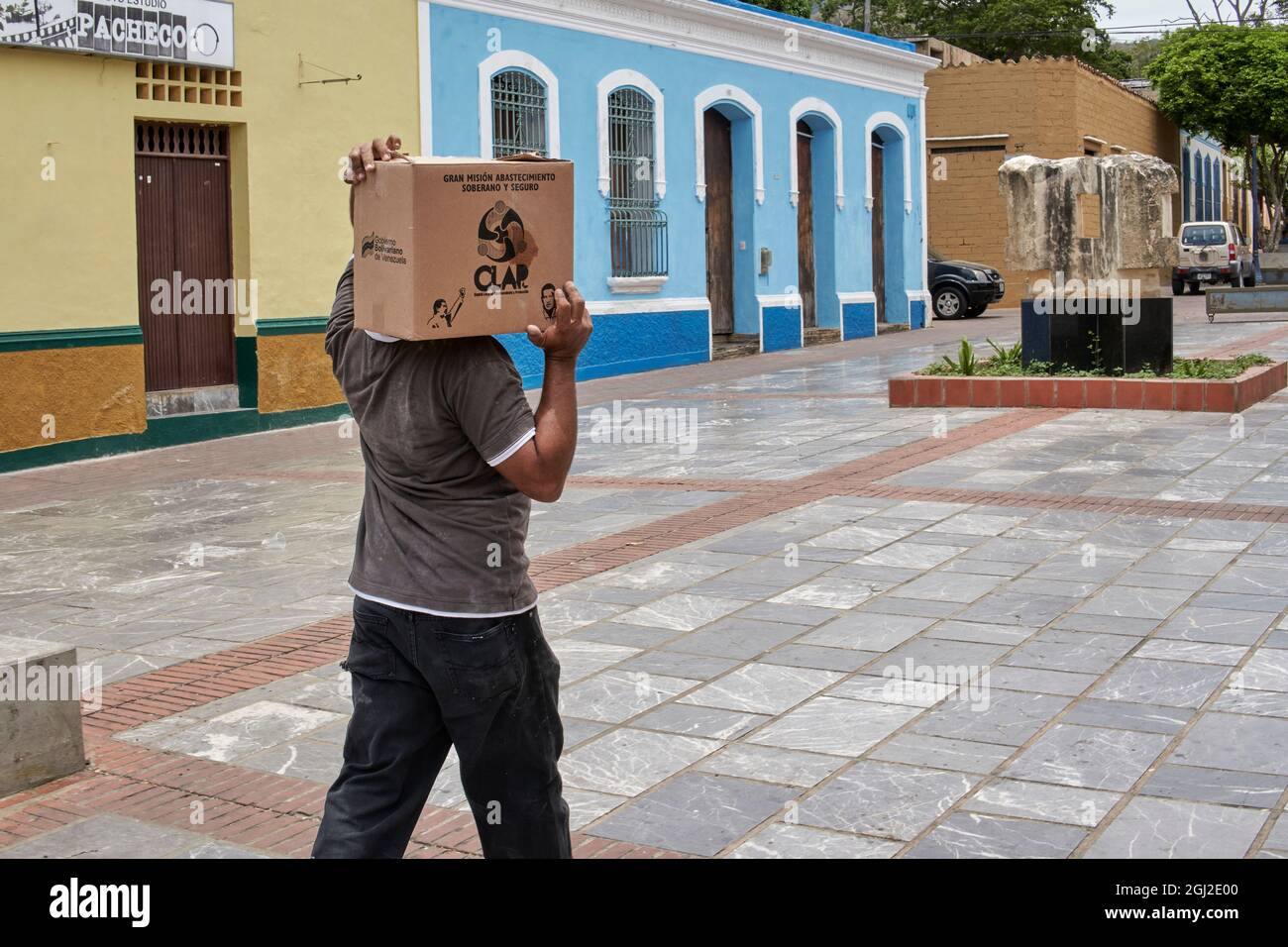 Man Carrying a Venezuelan Clap food package Stock Photo