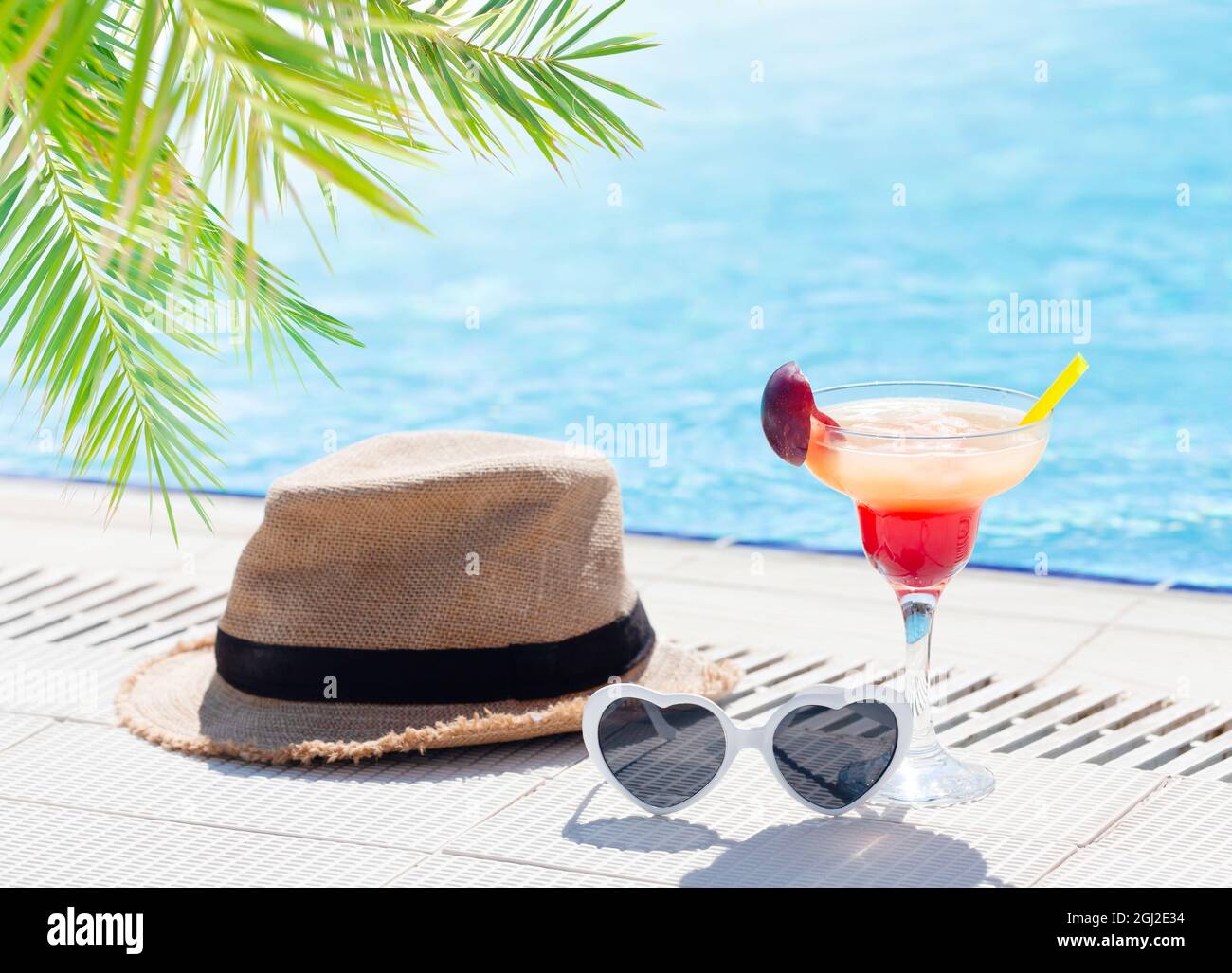 Tropical cocktail glass, sun hat and 