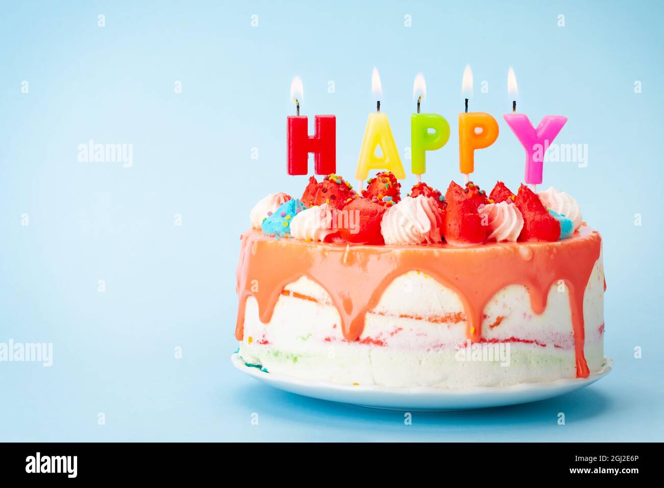 Birthday cake with happy birthday candles on blue background with copy ...