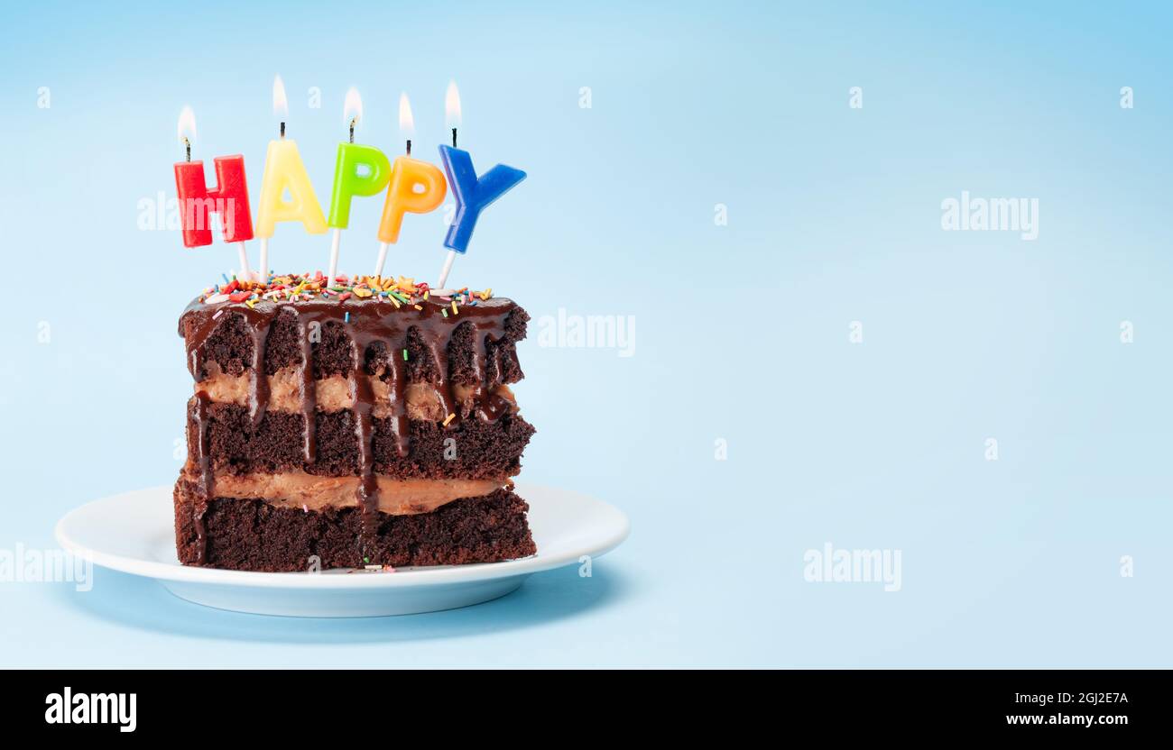 Birthday cake with happy birthday candles on blue background with copy ...