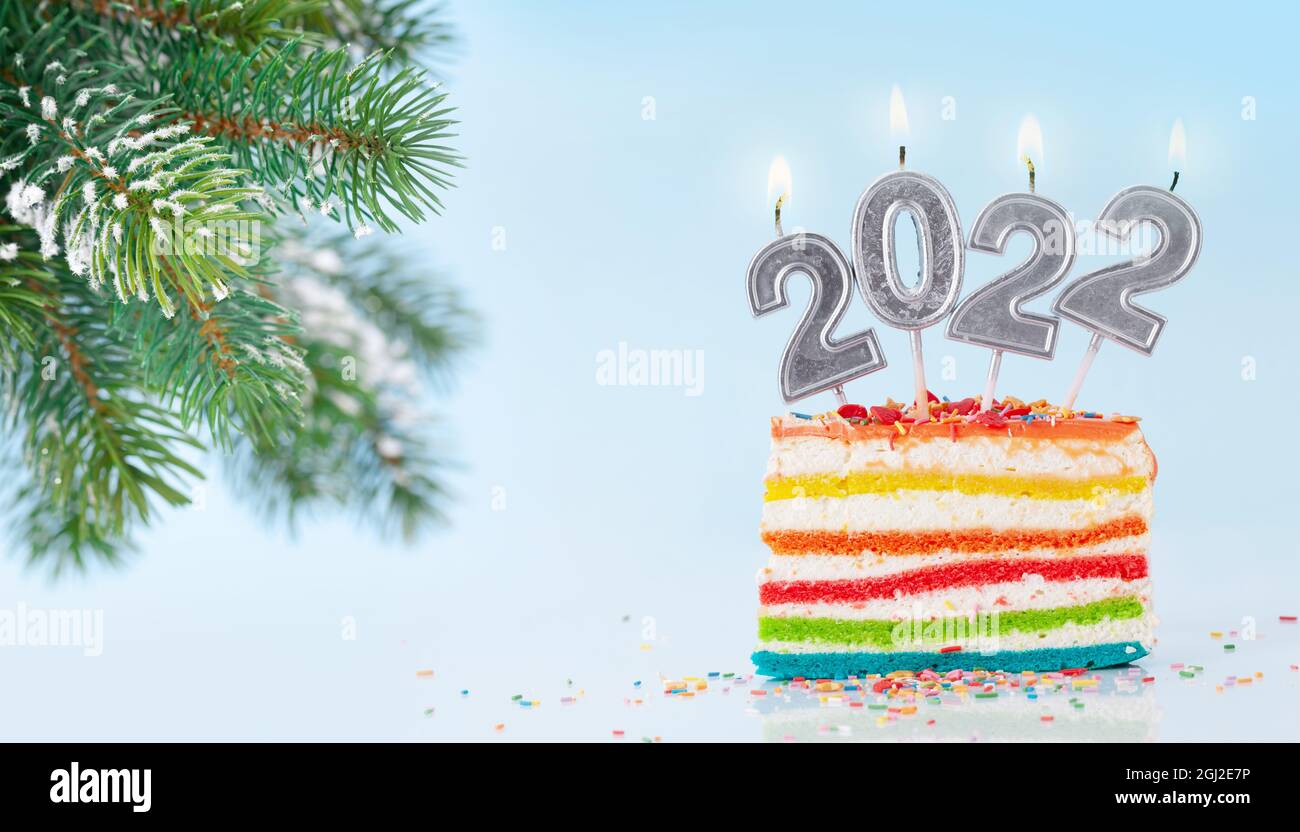 Christmas Cake With Number 2022 Burning Candles On A Blue Background And Fir Tree Branch Stock Photo - Alamy
