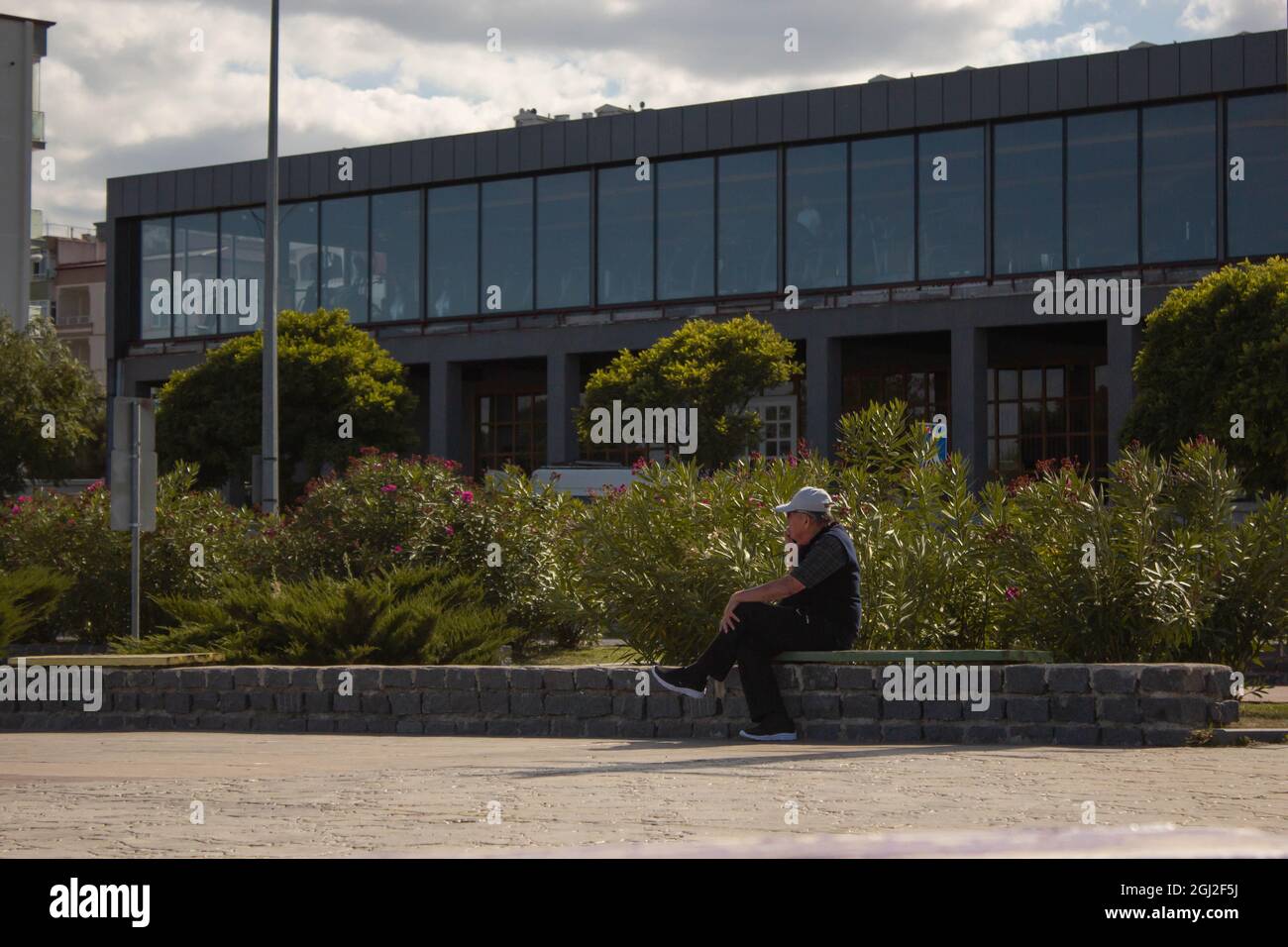An old man talking on the phone about his business. Working old man managing his business by phone. Stock Photo