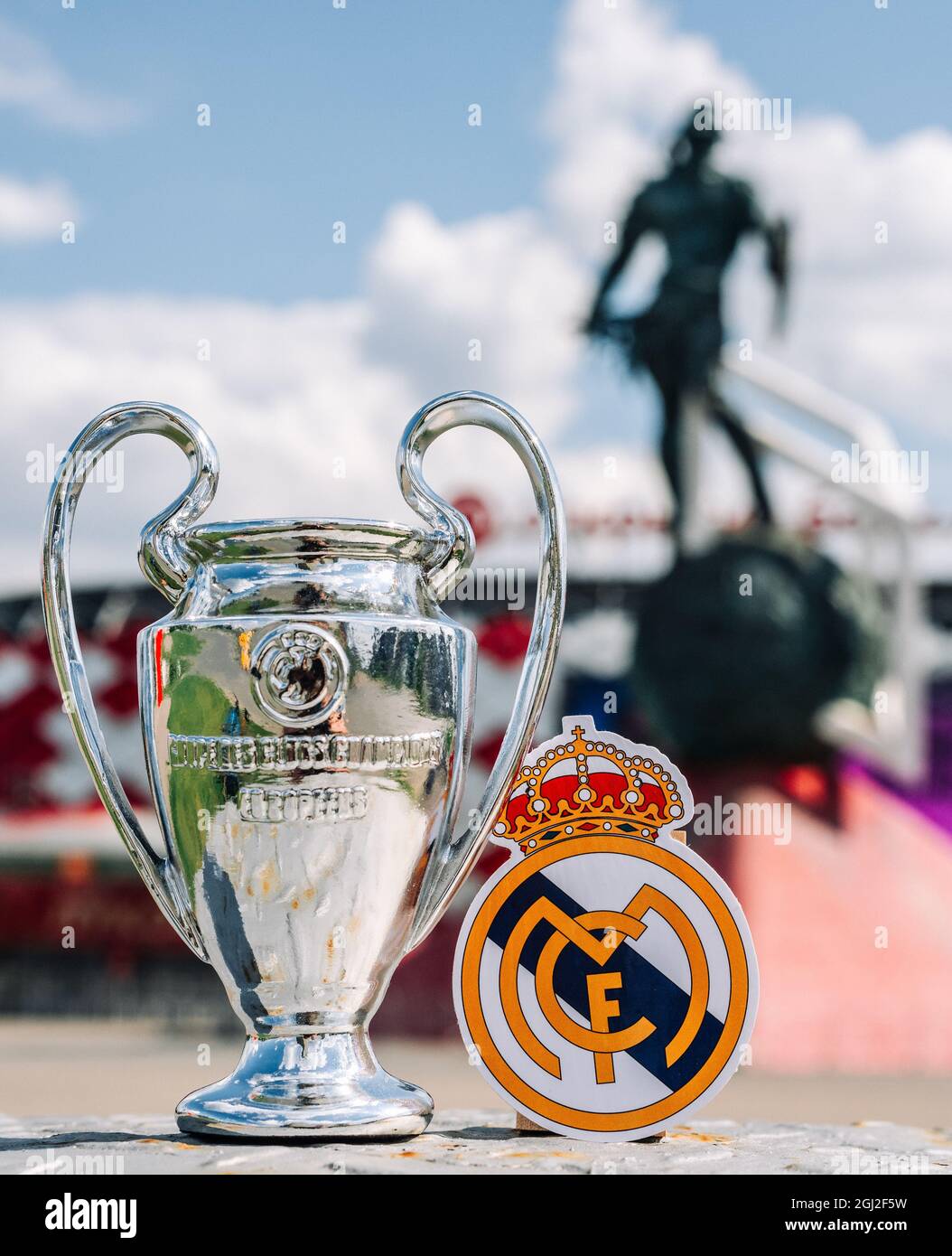 June 14, 2021 Madrid, Spain. The emblem of the Real Madrid CF football club and the UEFA Champions League Cup against the backdrop of a modern stadium Stock Photo