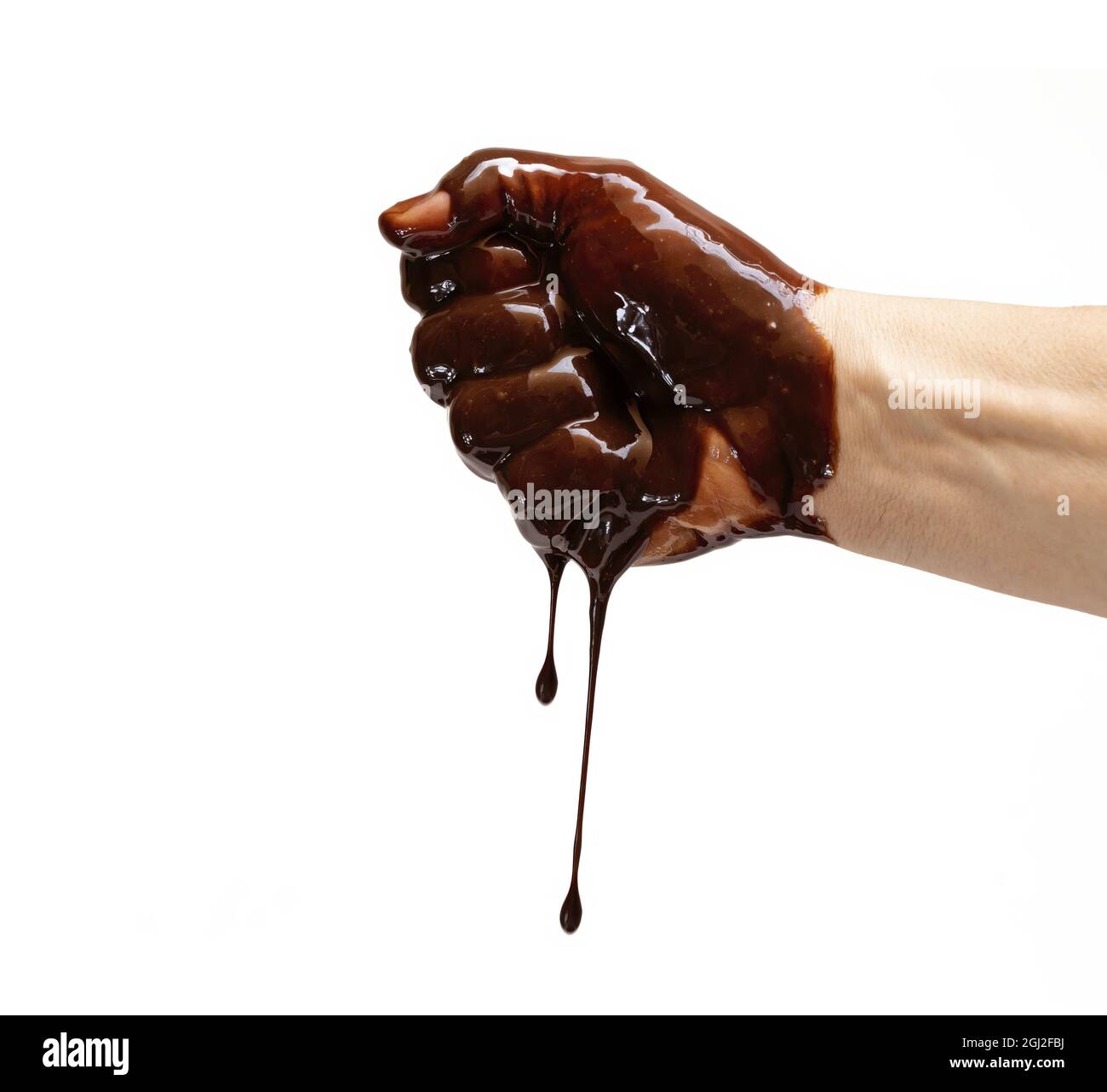 A Mediterranean Caucasian Hand Clenches The Fist Of Dripping Chocolate White Background Stock