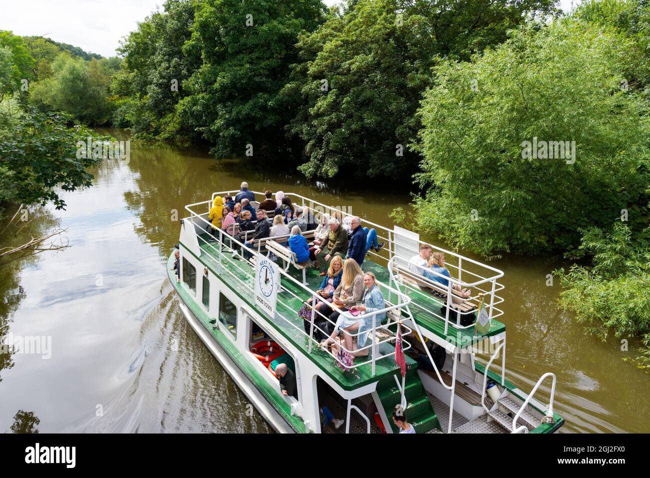 Passengers aboard and riverboat on River Avon. Pulteney Cruisers are the longest established boat tour operator in Bath. Stock Photo