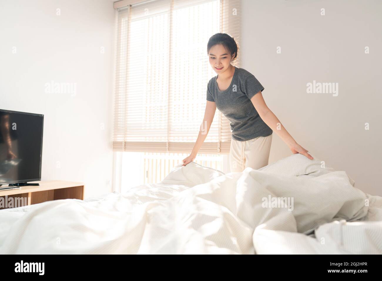 Bedroom concept a female adult doing the routine by grabbing the edge ...