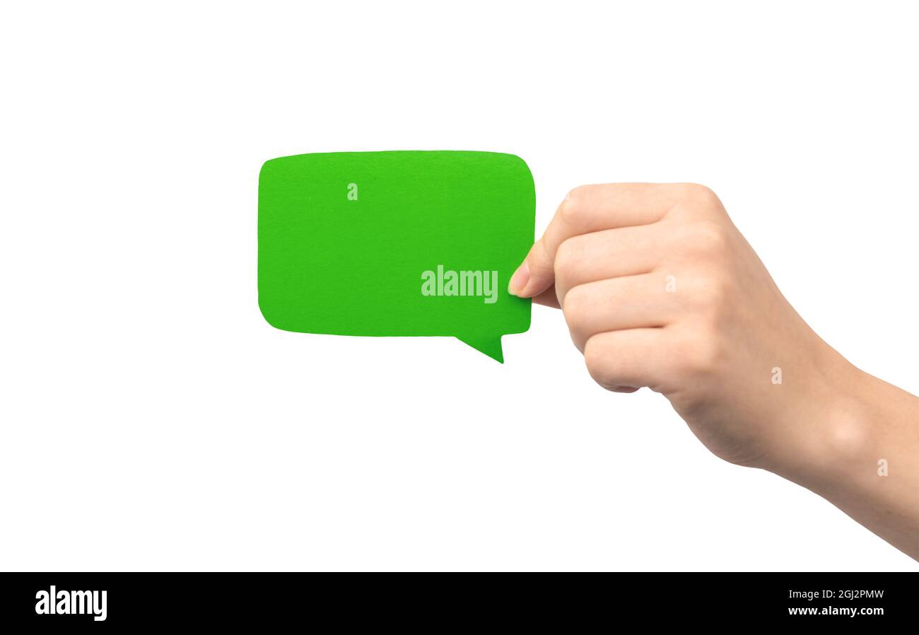 Green speech bubble in hand isolated on a white background. Giving ...