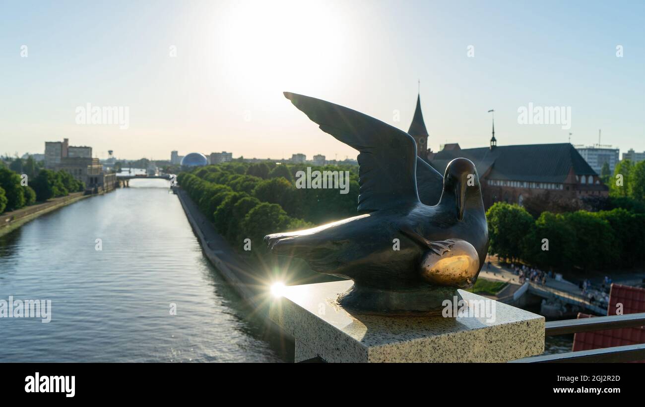 Sculpture The Bird of Happiness with a golden egg on the upper platform of the lighthouse in the Fishing village, Kaliningrad, Russia. Stock Photo