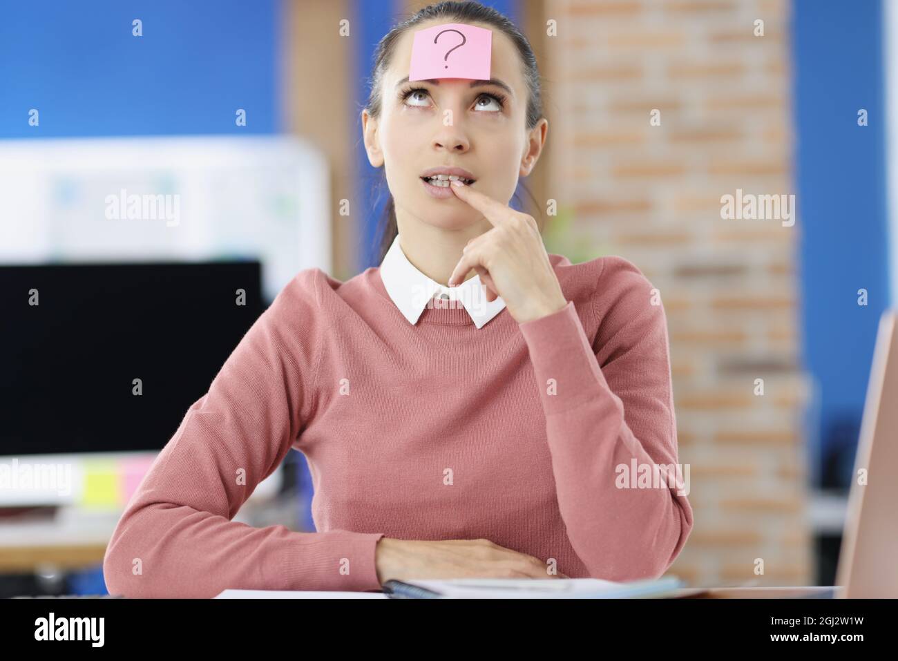 Pensive woman on head with sticker with question mark Stock Photo