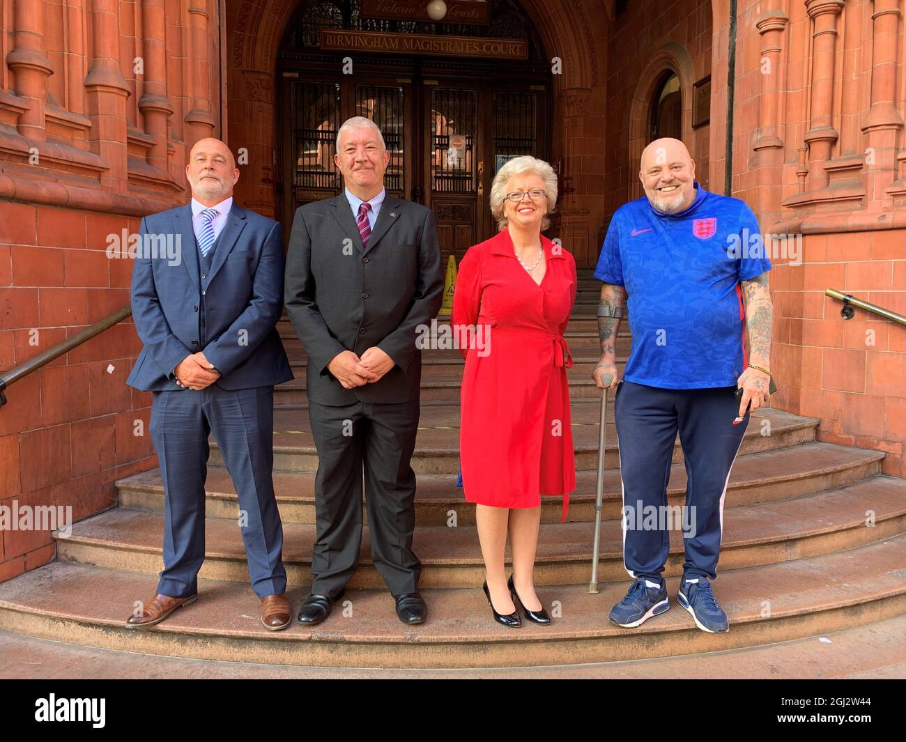 Julie Hambleton with Kevin Gormley (left), Michael Lutwyche (middle left) and John Porter (right) on the steps of Birmingham Magistrates' Court. Miss Hambleton, who was cleared today of taking part in a lockdown-breaking gathering has accused the police of 're-traumatising' the families of the blasts' victims. Issue date: Wednesday September 8, 2021. Stock Photo