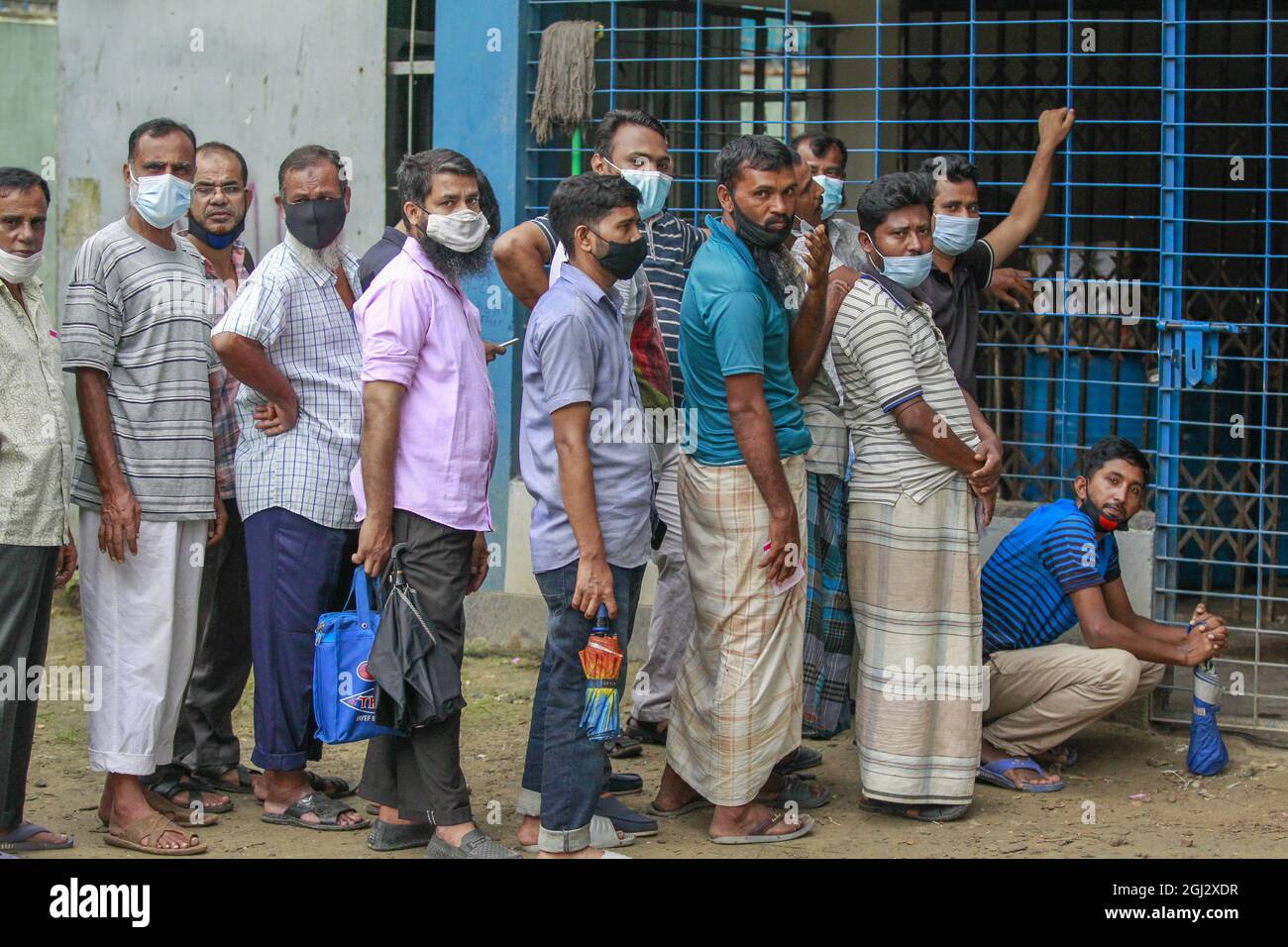 people wait in a queue to receive the second douse of covid 19 vaccine at an inoculation center as the government takes its vaccination drive to the grassroots in dhaka bangladesh september 8 2021 photo by suvra kanti dassipa usa 2GJ2XDR