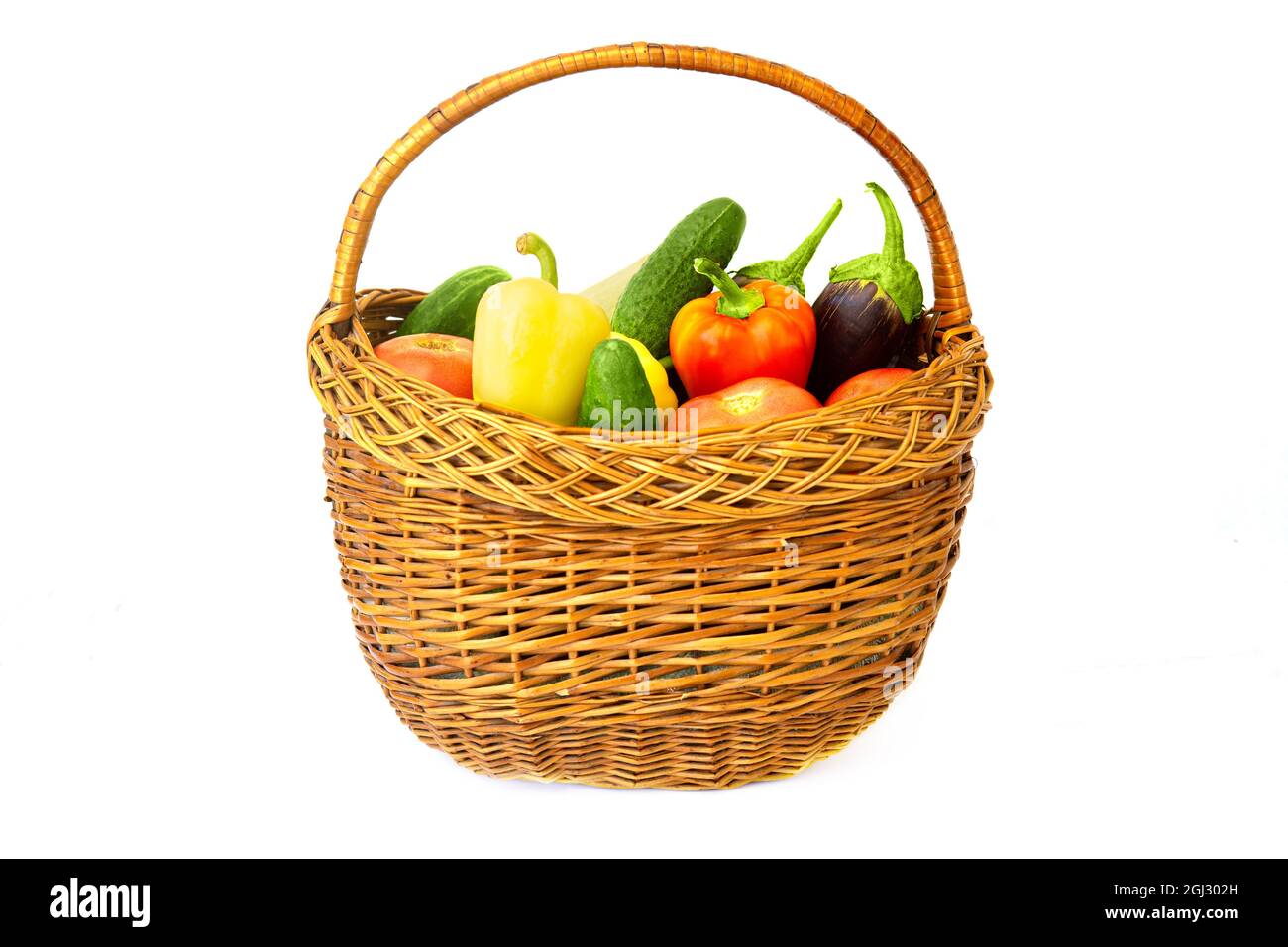Assorted vegetables in a wicker basket isolated on white Stock Photo
