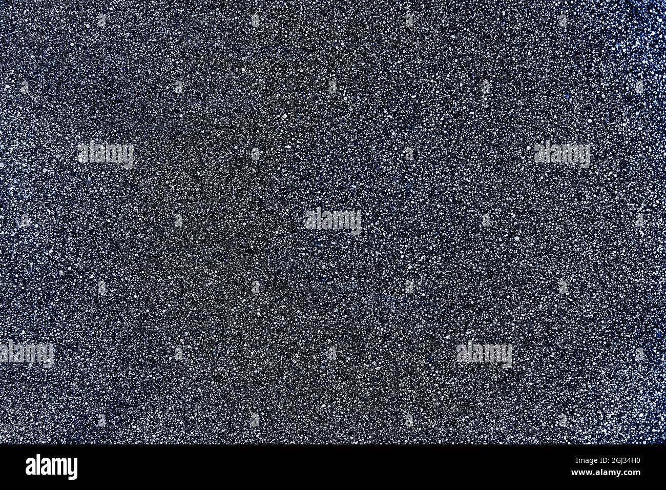 Gray surface with fine texture and white dots. Abstract neutral background for design. Backdrop Stock Photo