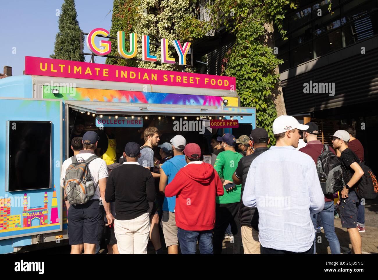 Multicultural UK; People buying street food from a Gully Indian Street Food stall, the Oval, Kennington London UK, example of multicultural London Stock Photo