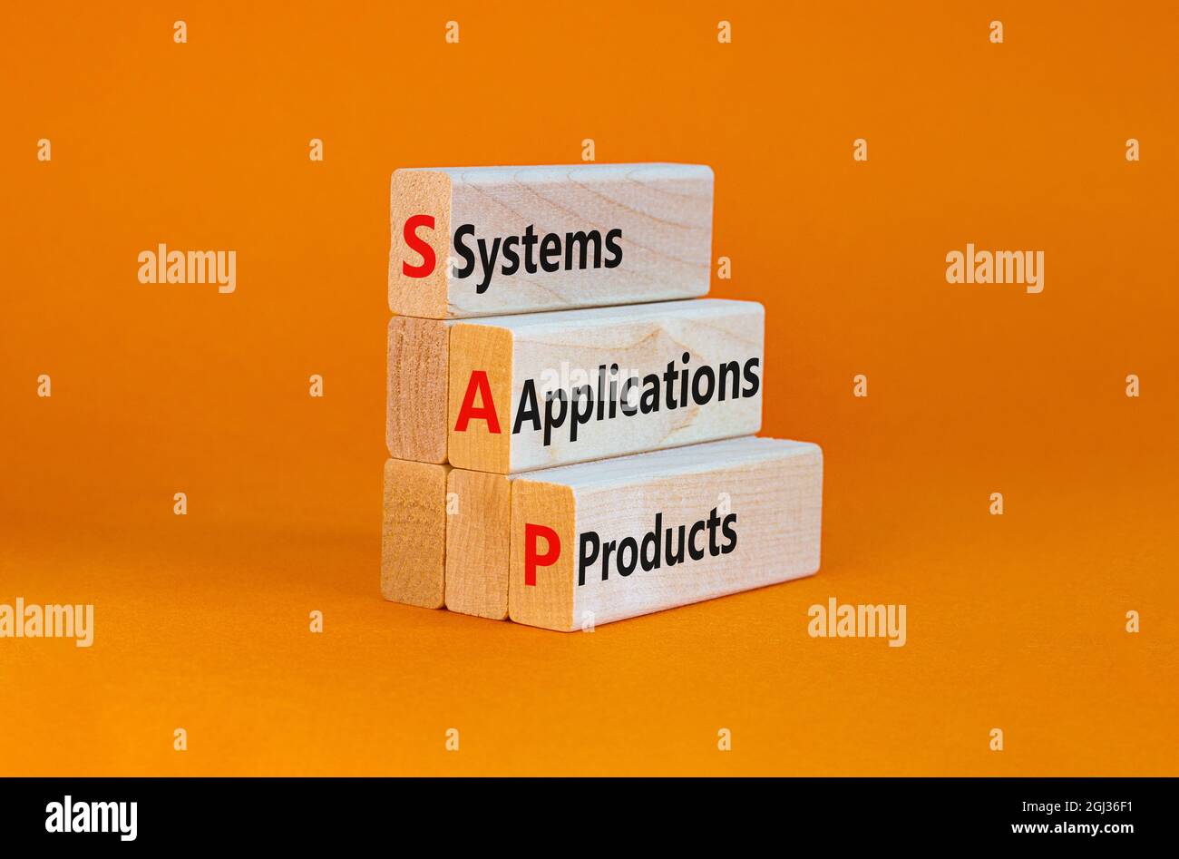 SAP, systems, applications, products symbol. Wooden blocks with words SAP, systems, applications, products. Orange background, copy space. Business an Stock Photo