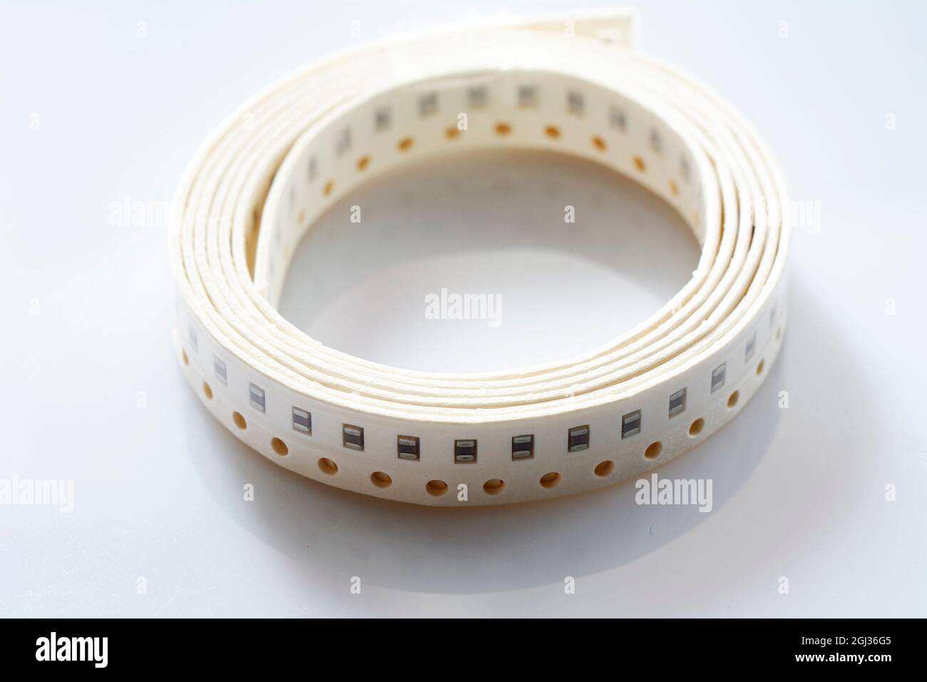 Electronic component on white background. SMD components in black plastic carrier tape with copyspace Stock Photo