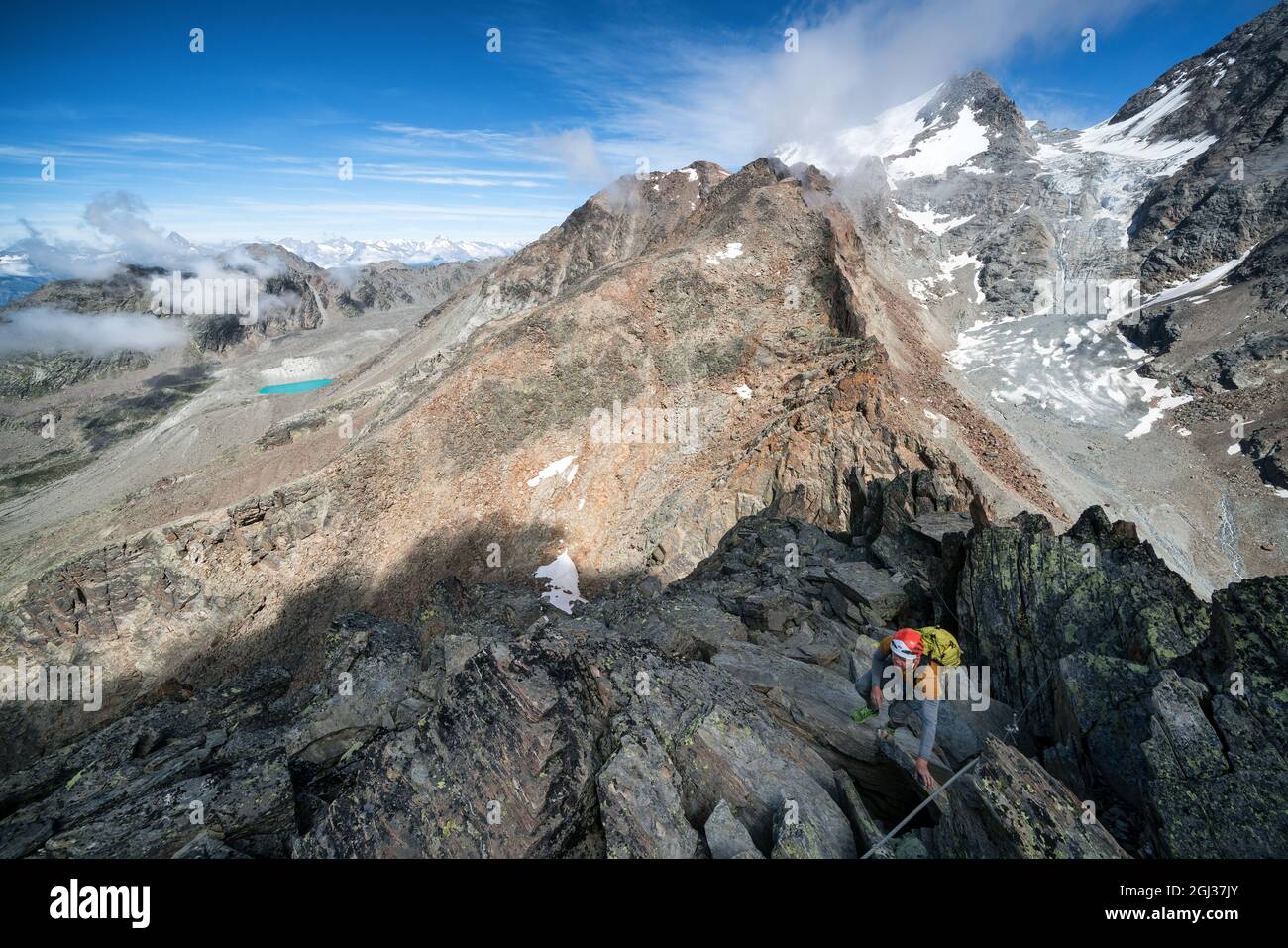 Hiking towards the true summit after rock climbing Jegihorn mountain, Saas-Grund, Switzerland Stock Photo