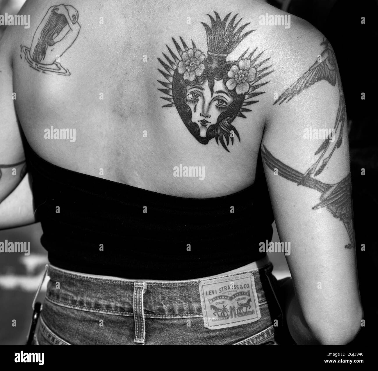 A young woman with a Sacred Heart tattoo on her back in Santa Fe, New Mexico. Stock Photo