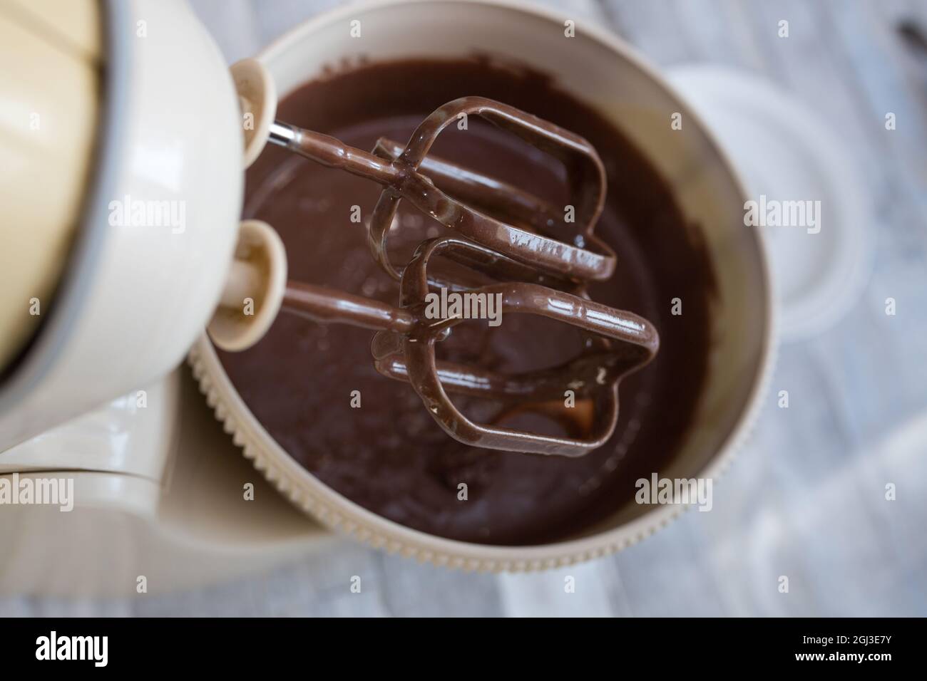 Cake making process. The dough is ready. The mixer beaters are stopped. Step by step recipe for chocolate cake. Series. Baking concept. Stock Photo