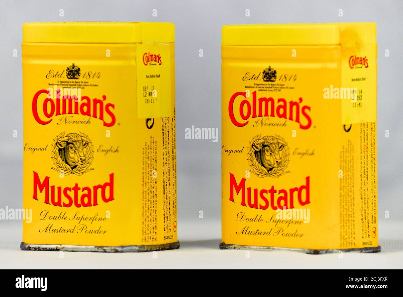 Colman's English Mustard tins arranged on a white background. Stock Photo