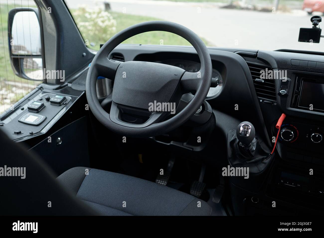 Close-up of drivers seat, bus dashboard and steering wheel, view