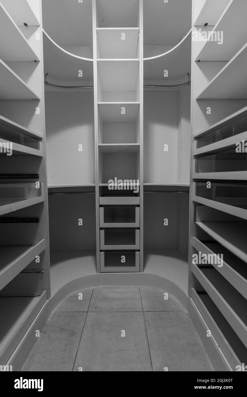 Greyscale view of a shelf with many drawers in the room in the apartment Stock Photo