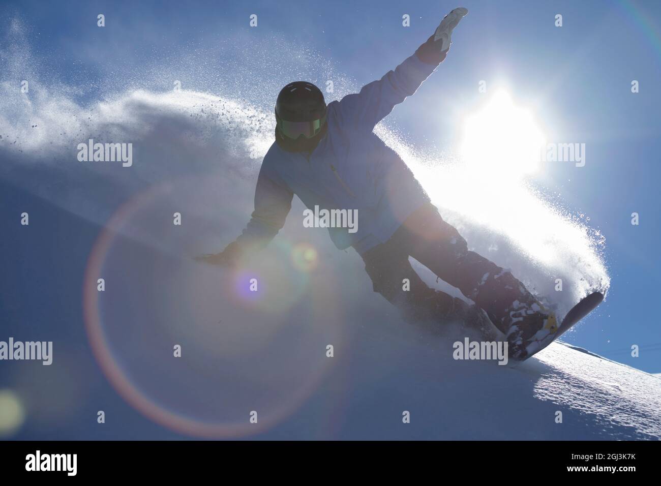 Snowboarder riding fresh powder on a bluebird day in the Andes Mountain range Stock Photo