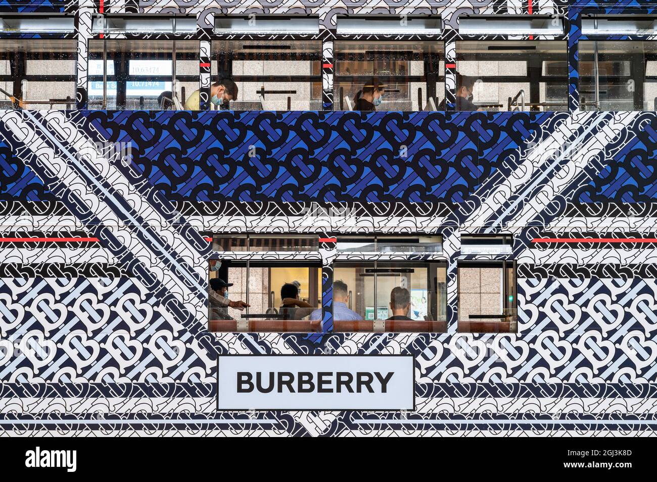 Commuters ride on a double-deck tram covered with the British luxury  fashion company Burberry brand advertisement theme in Hong Kong. (Photo by  Budrul Chukrut / SOPA Images/Sipa USA Stock Photo - Alamy