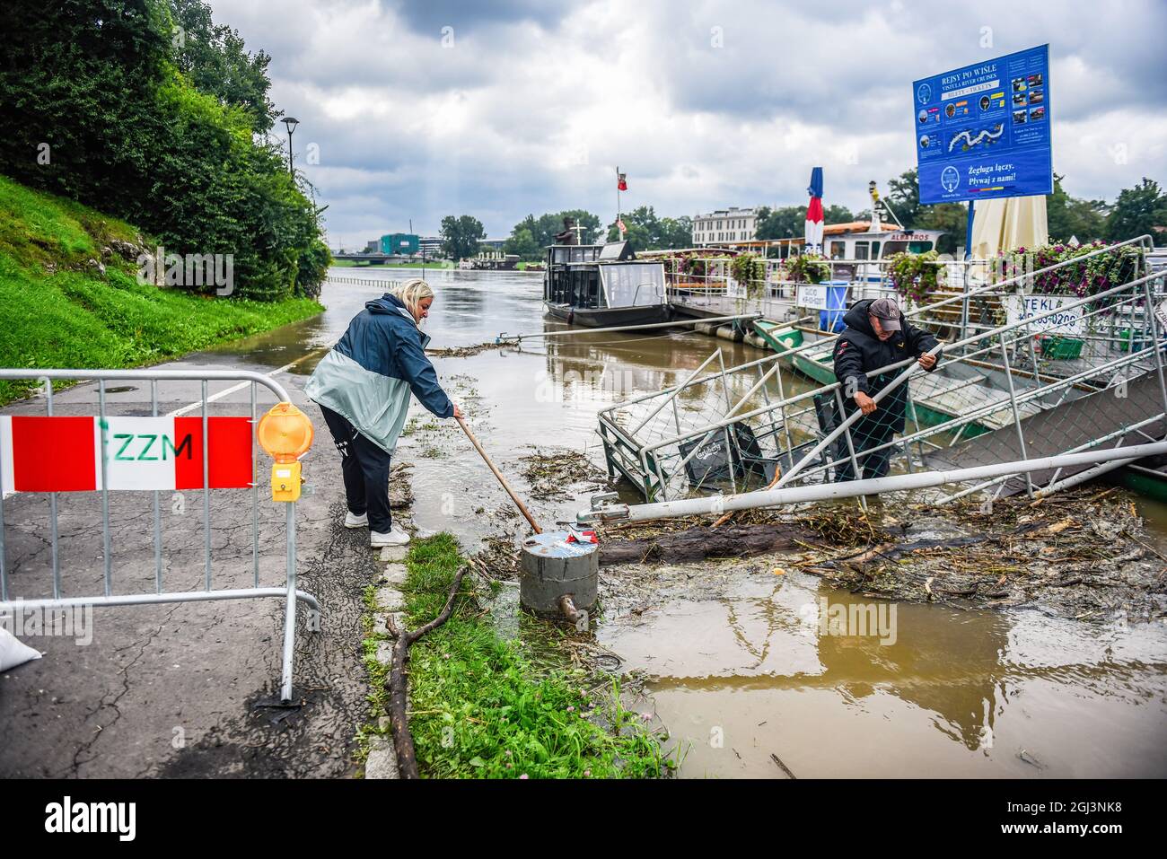 People seen trying to remove the wood that brought by the high level of