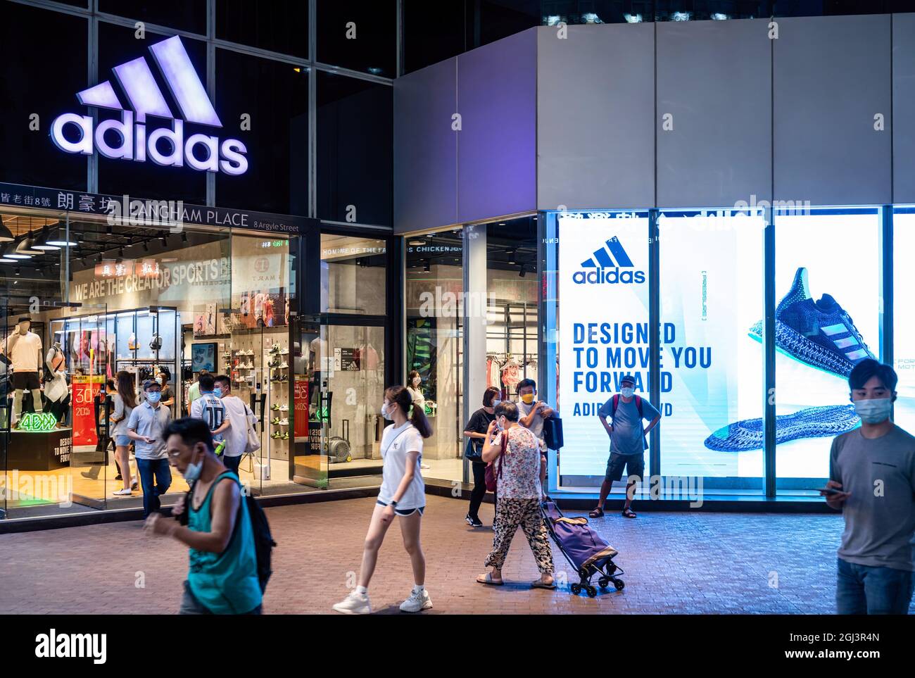 Pedestrians walk past the German multinational sportswear brand Adidas  store and logo in Hong Kong. (Photo by Budrul Chukrut / SOPA Images/Sipa  USA Stock Photo - Alamy