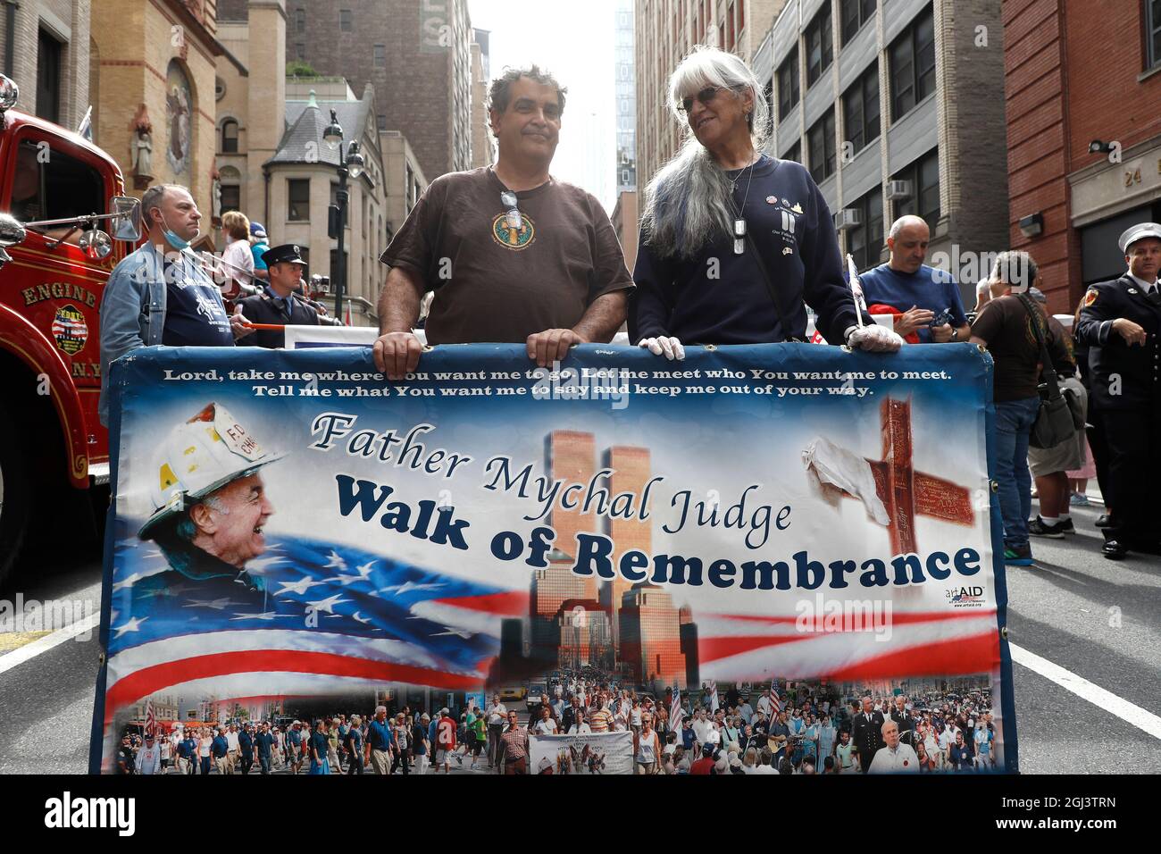 People pose with a banner Fire during the 911 Walk of Remembrance from St.  Francis of Assisi Church to St. Peters Church in downtown Manhattan. The  march has been performed yearly to