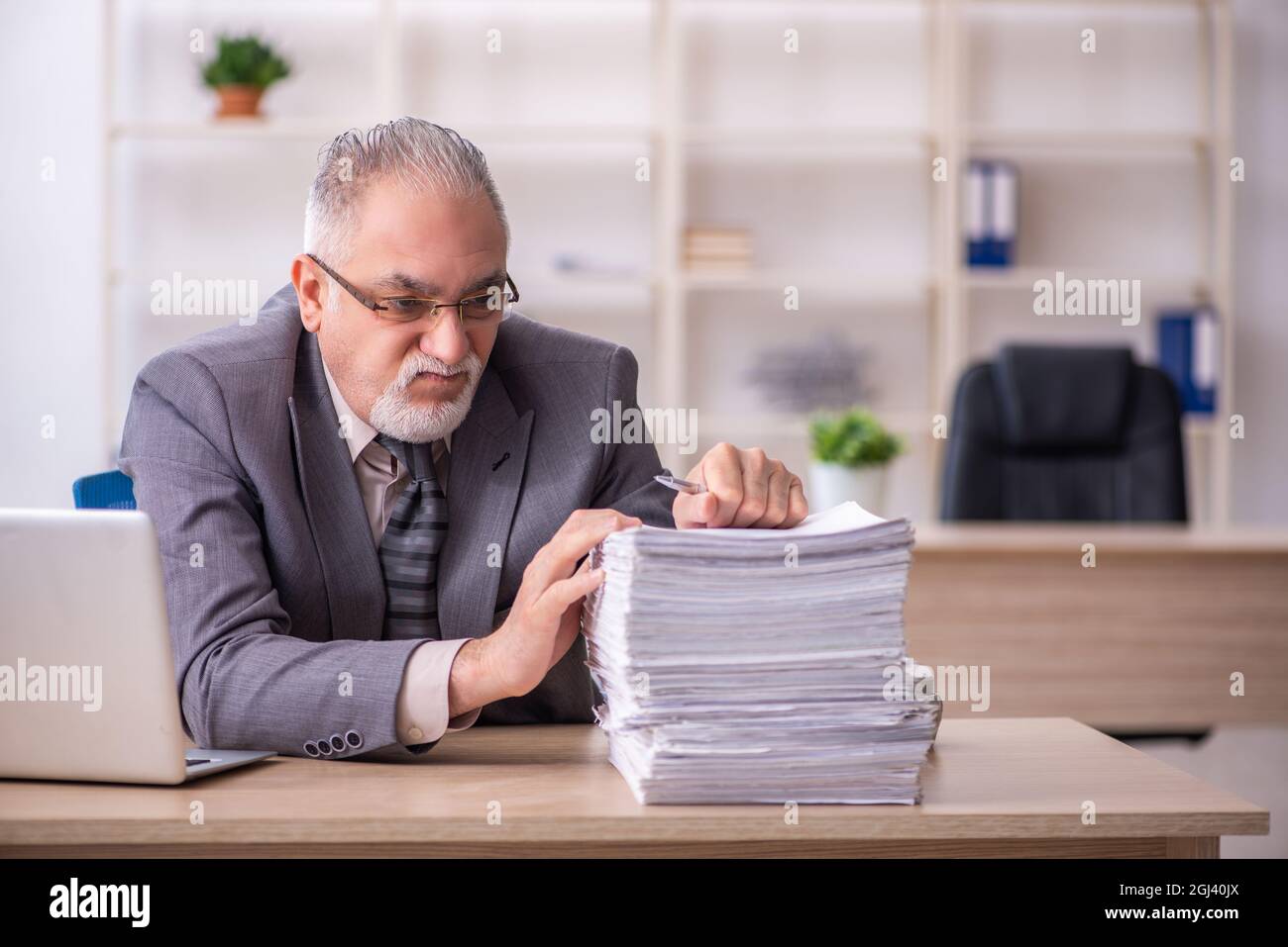 Old businessman employee working at workplace Stock Photo - Alamy