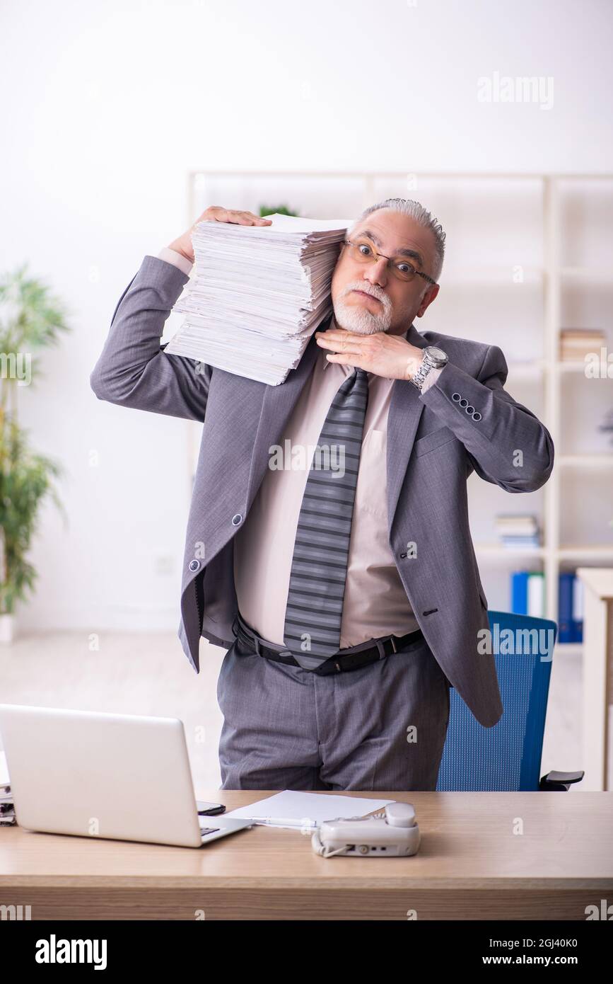Old businessman employee working at workplace Stock Photo - Alamy