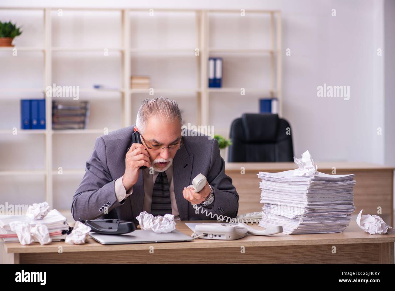 Old businessman employee working at workplace Stock Photo - Alamy