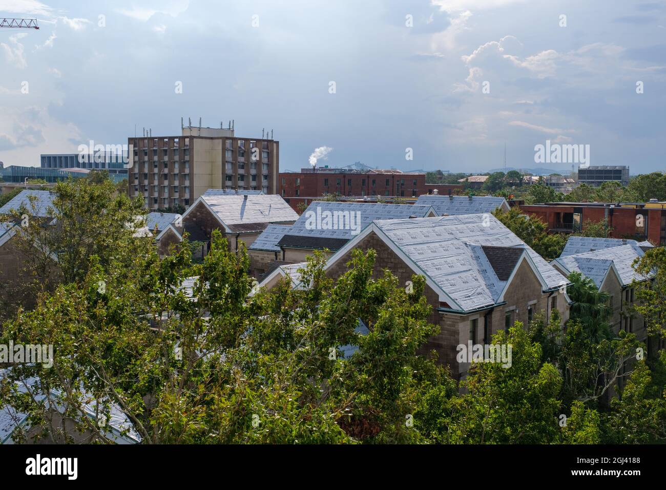 NEW ORLEANS, LA, USA - SEPTEMBER 7, 2021: Plastic Covered Roofs of Hurricane Ida Damaged Buildings at Tulane University Stock Photo