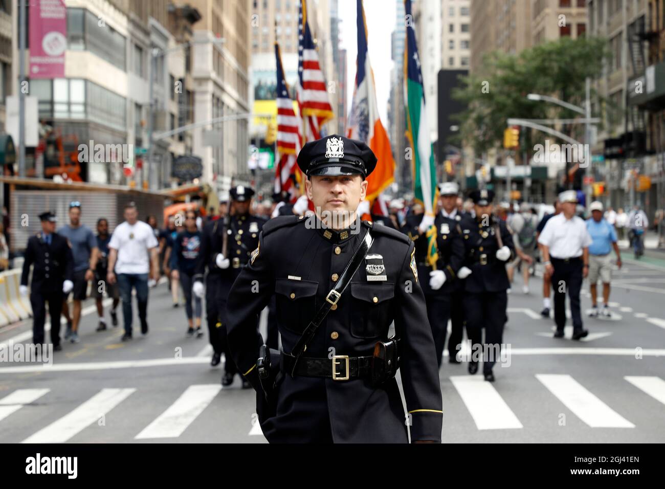 An NYPD officer marches with the color guard during the Father Mychal(01)