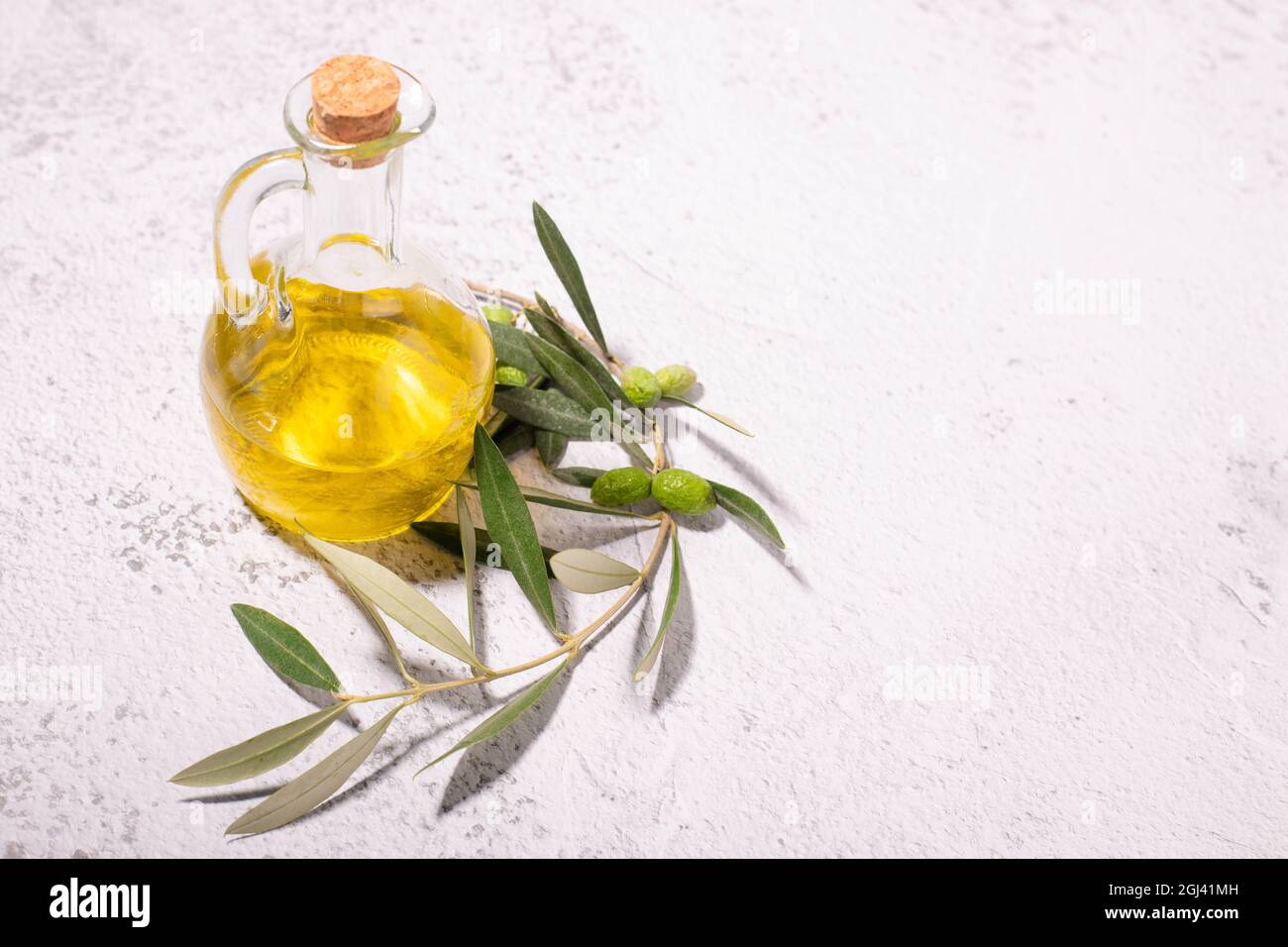 Cooking ingredients Aa glass jar with virgin olive oil, olive branch