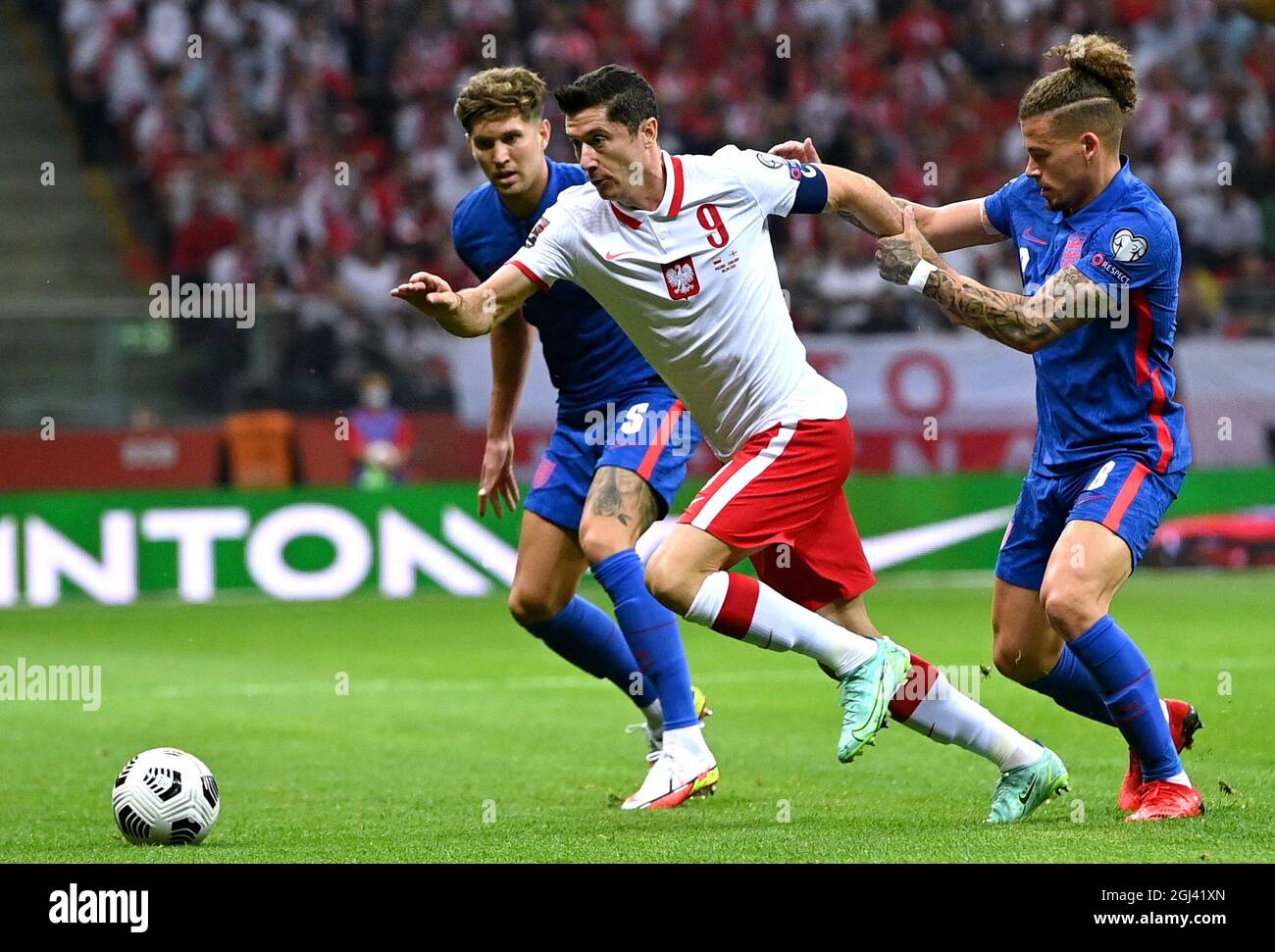 Poland's Robert Lewandowski (centre) battles for the ball with England ...