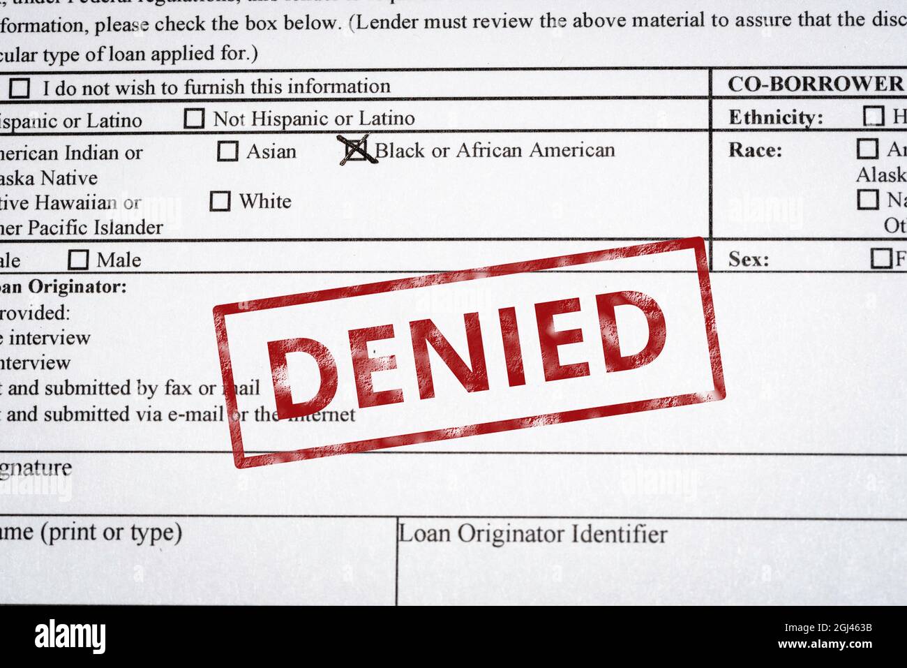 A mortgage application with black and African American box marked and a red denied stamp on it. Stock Photo