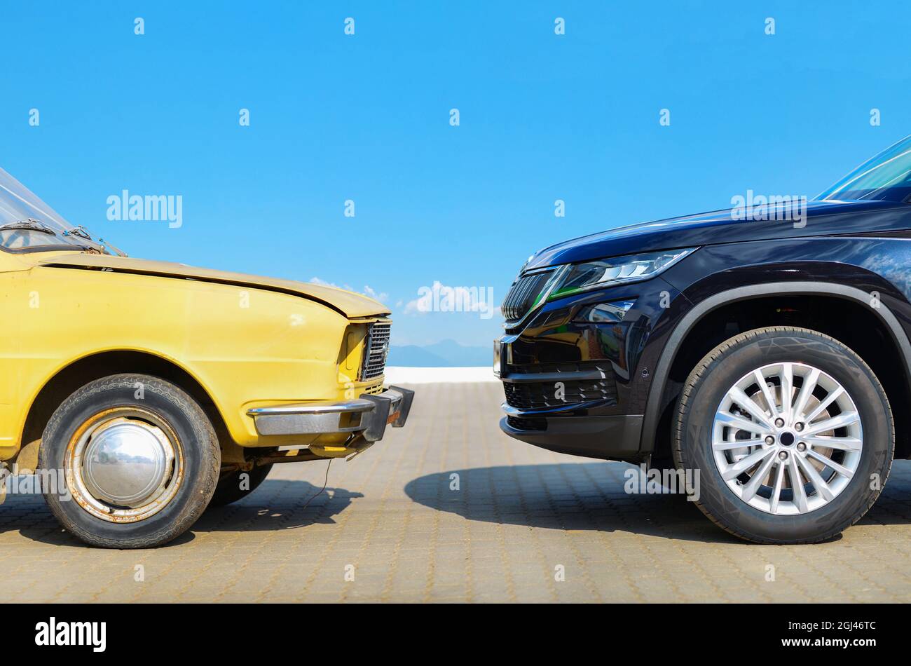 old car versus new car front face to face Stock Photo