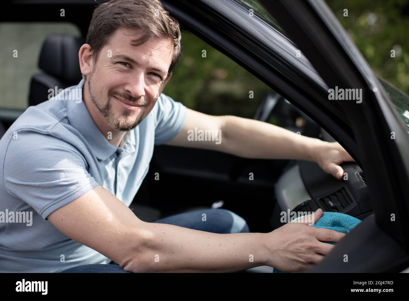 car cleaner wiping car door with rag Stock Photo Alamy