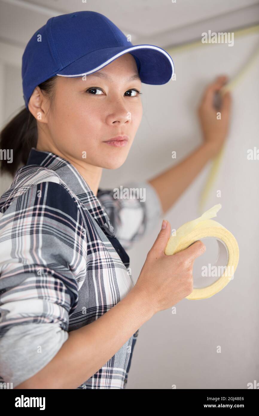 woman painter with masking tape before painting Stock Photo Alamy