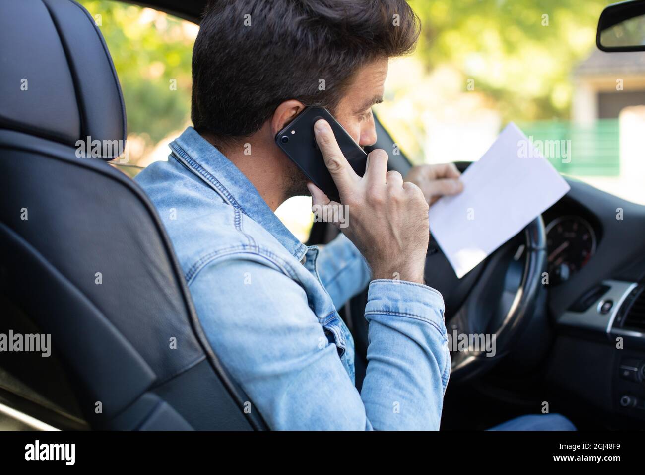 man driving car and calling from smartphone Stock Photo