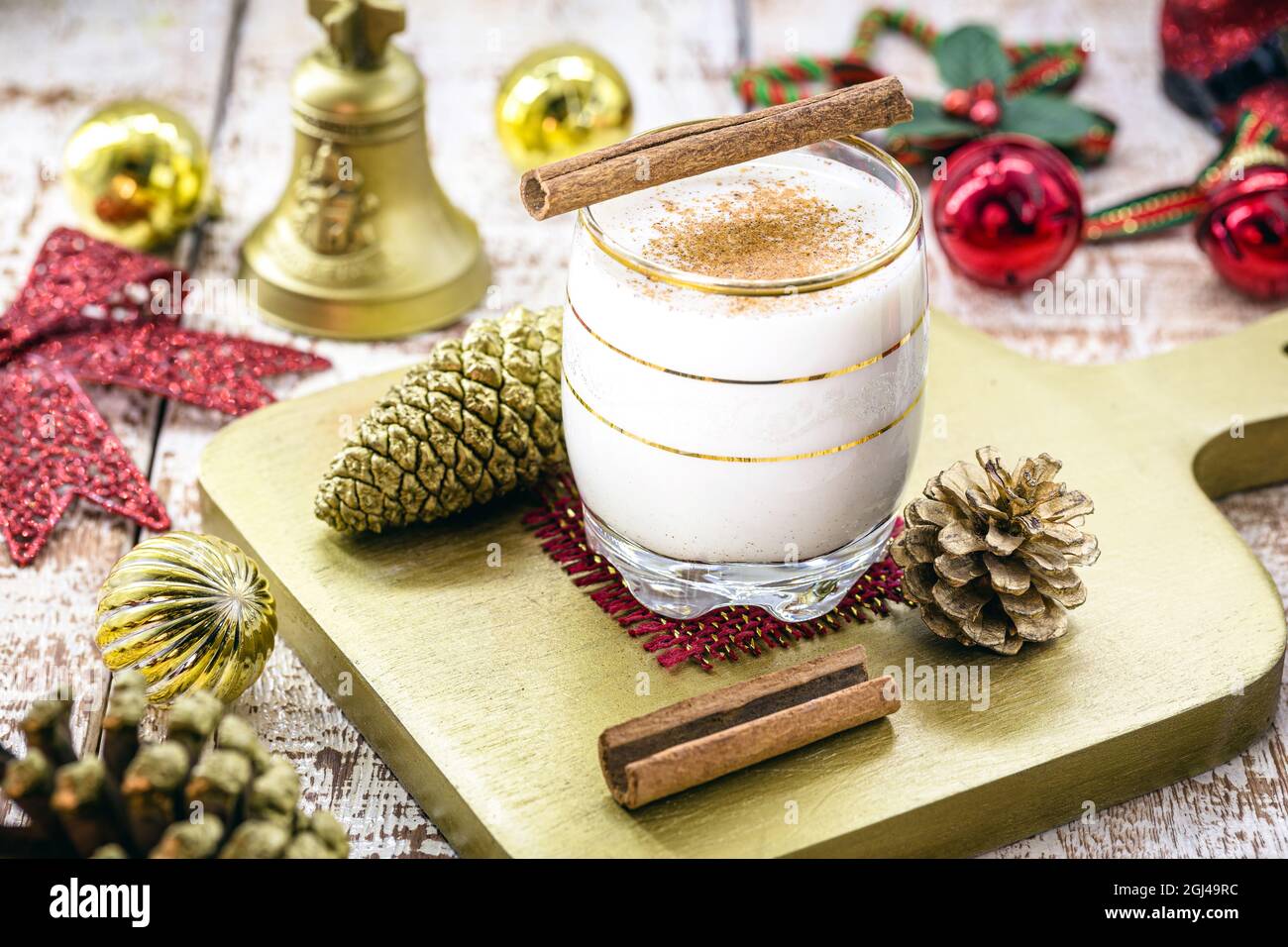 glass of hot eggnog, Christmas drink, based on eggs, cinnamon, almonds and rum liqueur. called