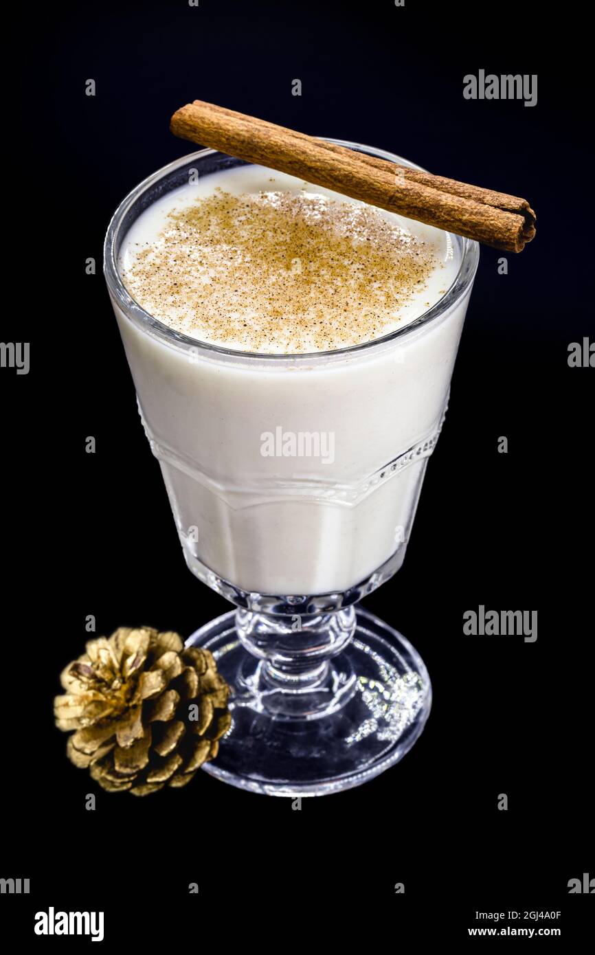 glass of hot eggnog, Christmas drink, made with eggs, cinnamon, almonds