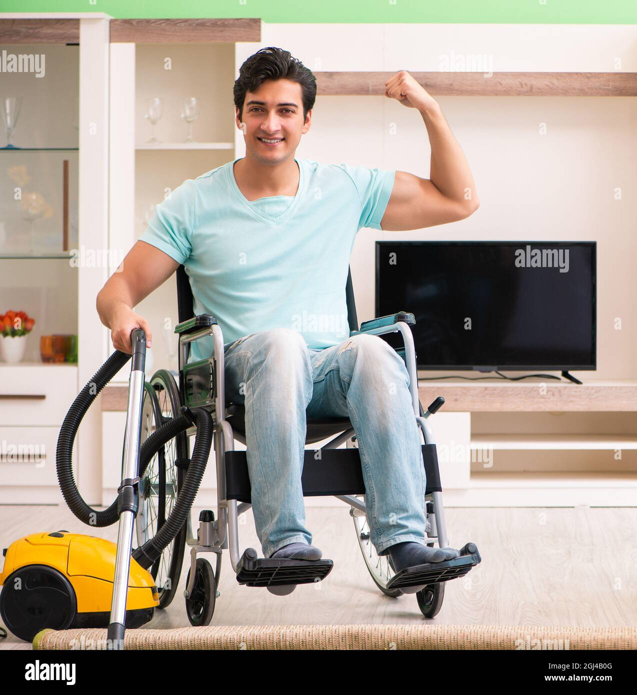 The disabled man on wheelchair vacuum cleaning house Stock Photo Alamy