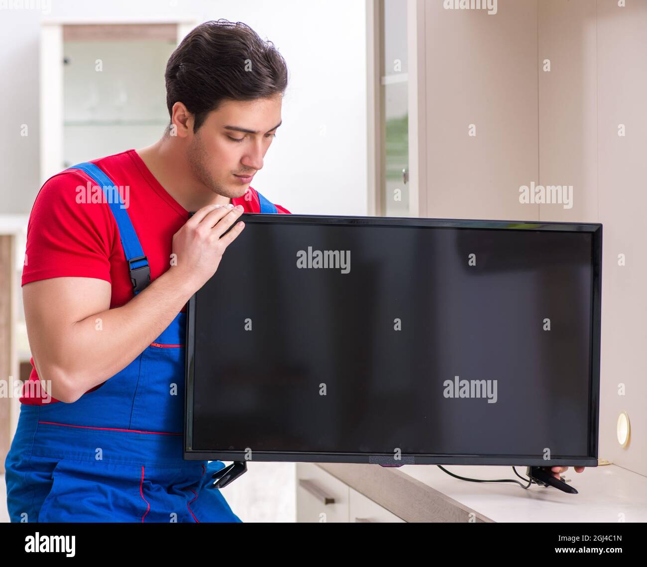 Tv Engineering Making The professional repair engineer repairing broken tv Stock Photo - Alamy