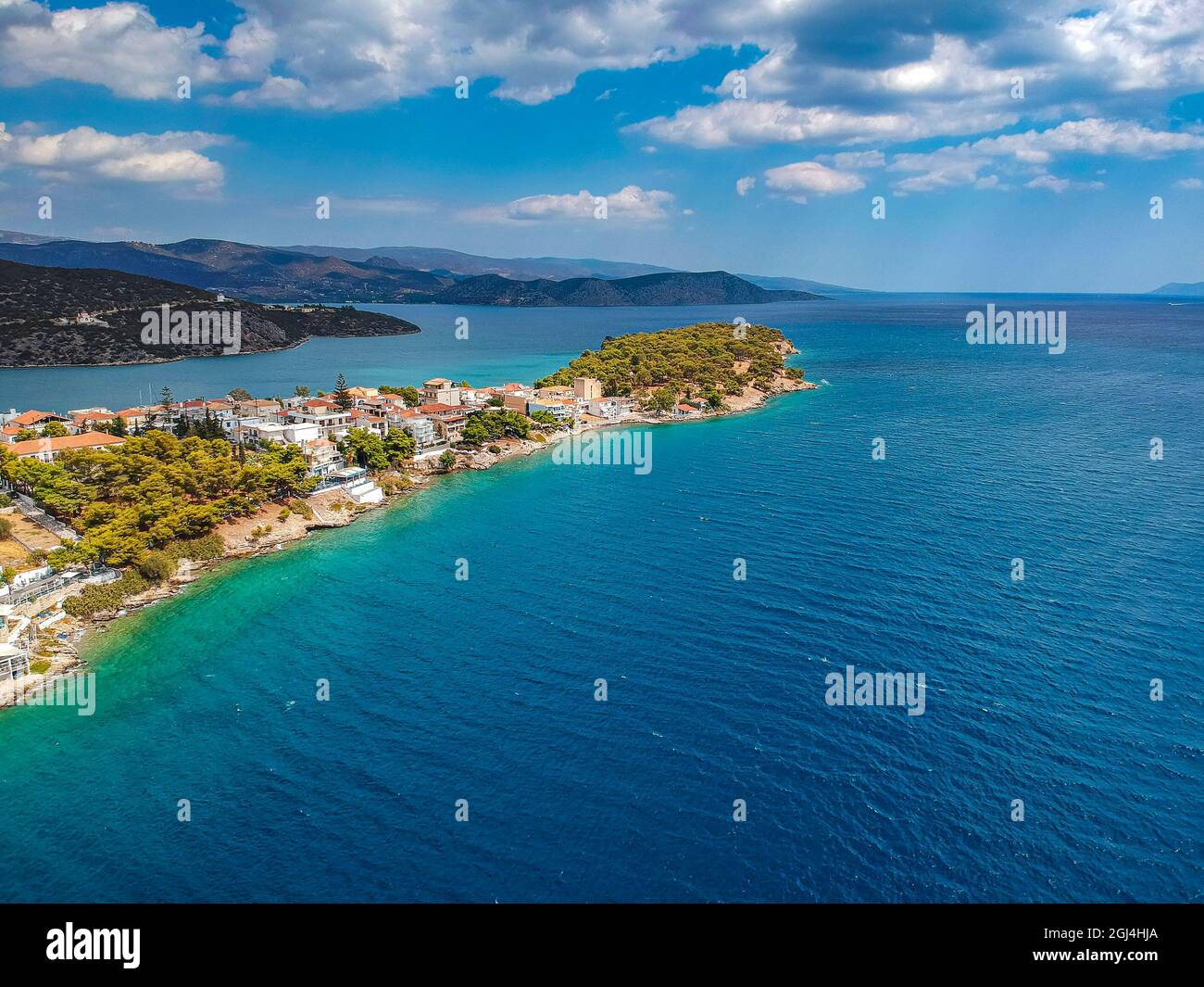 Aerial panoramic photo of picturesque seaside town of Ermioni built in peninsula with forest of Bistis at the end, Argolida, Peloponnese, Greece Stock Photo